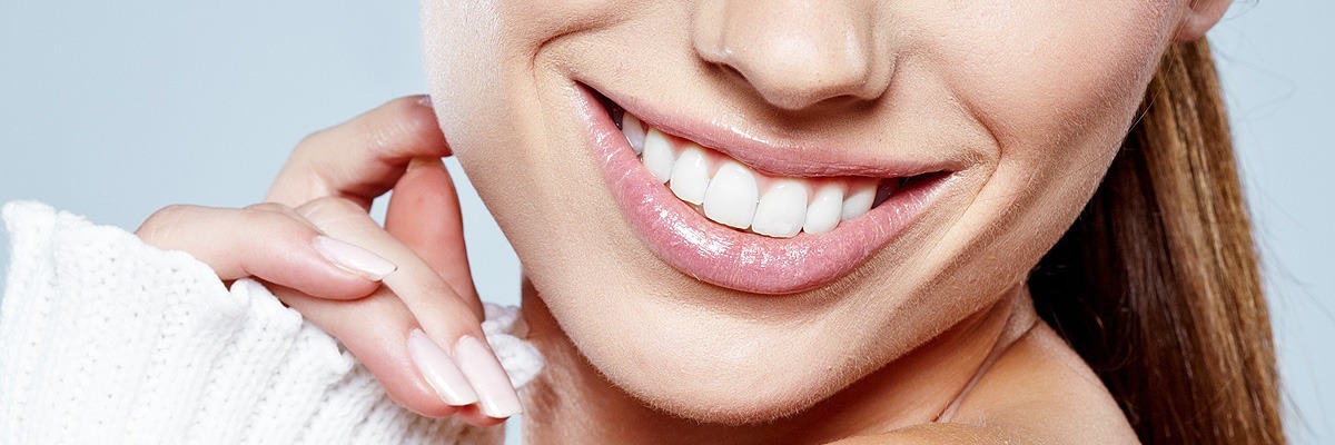 Woman posing after her teeth whitening procedure