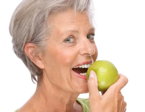Woman eating a fruit
